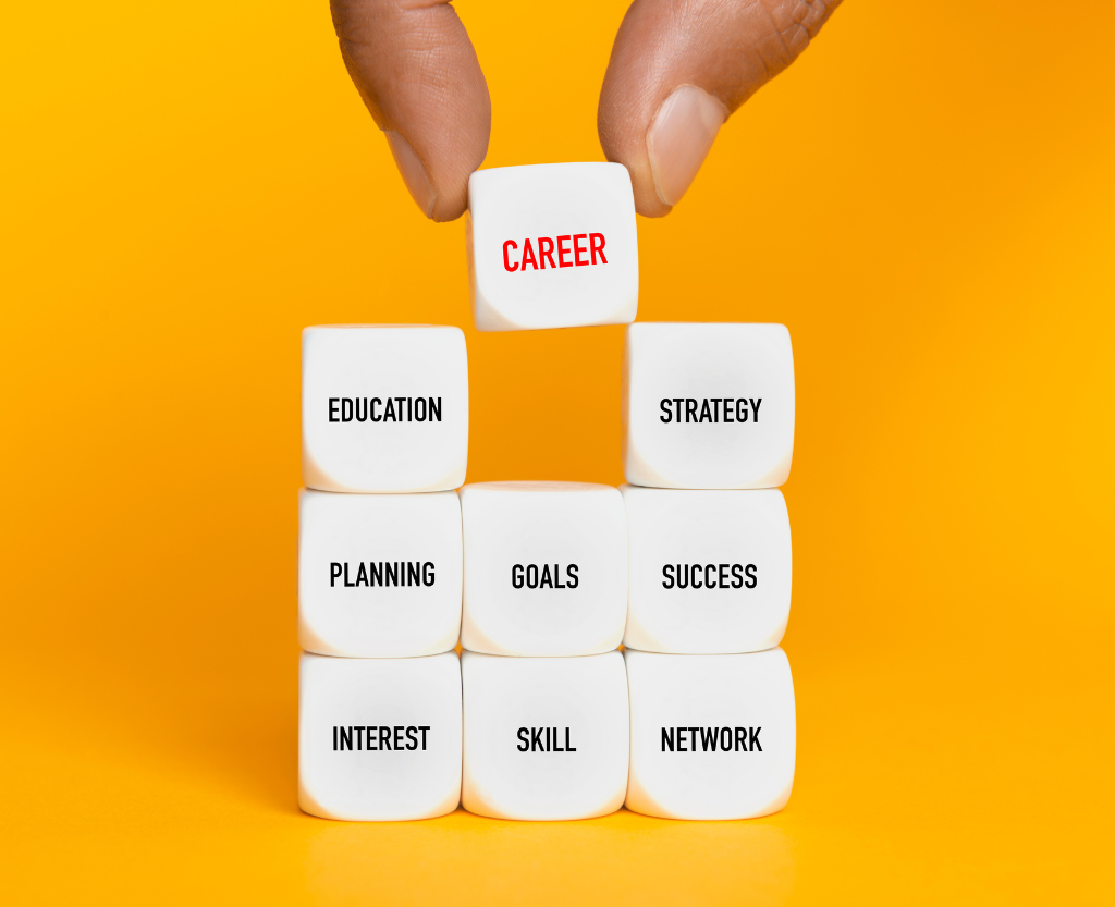 Hand dropping dice into a group of dice with the word career on it
