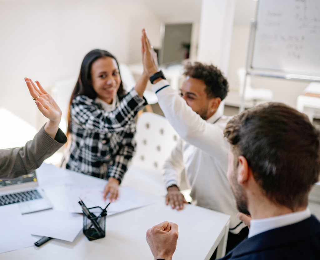 Group high fiving each other over success