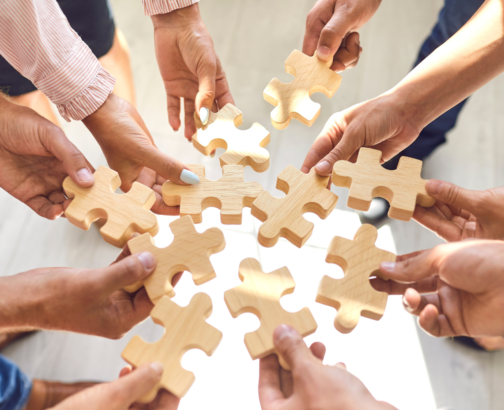 People putting puzzle pieces in together